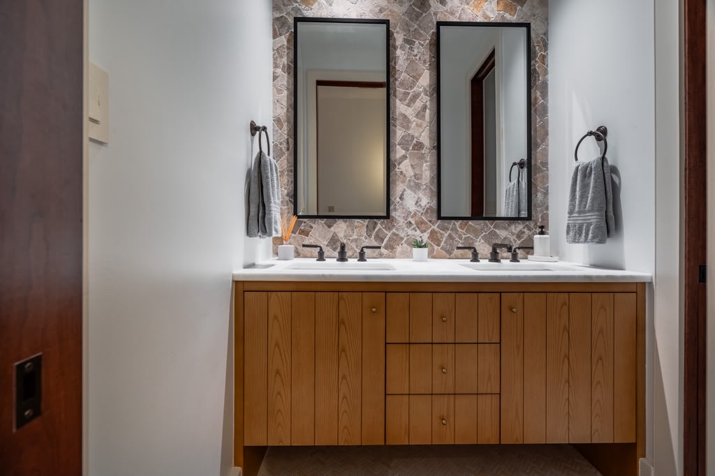 Custom wood vanity and stone feature wall in the new bathroom