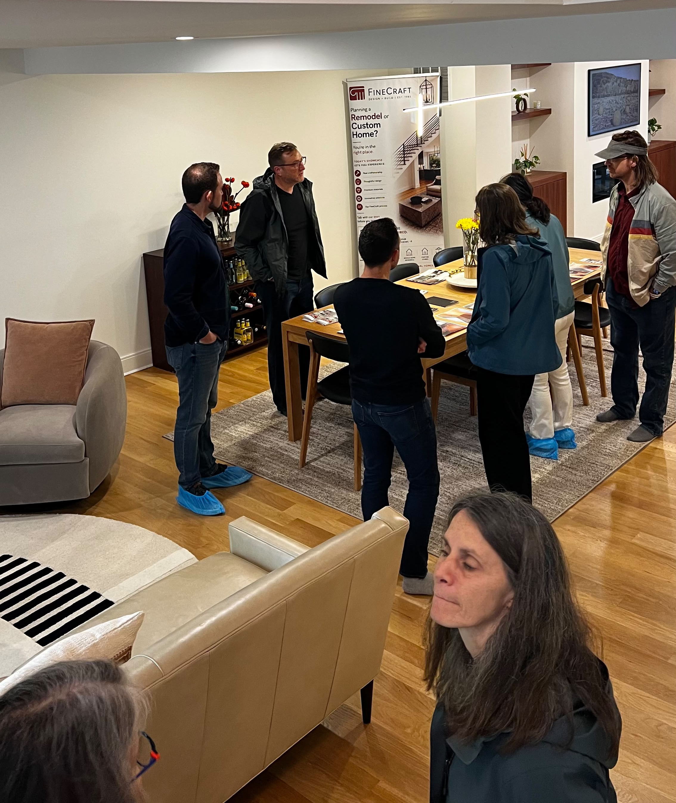 Guests gathering in the open living and dining spaces during the tour.